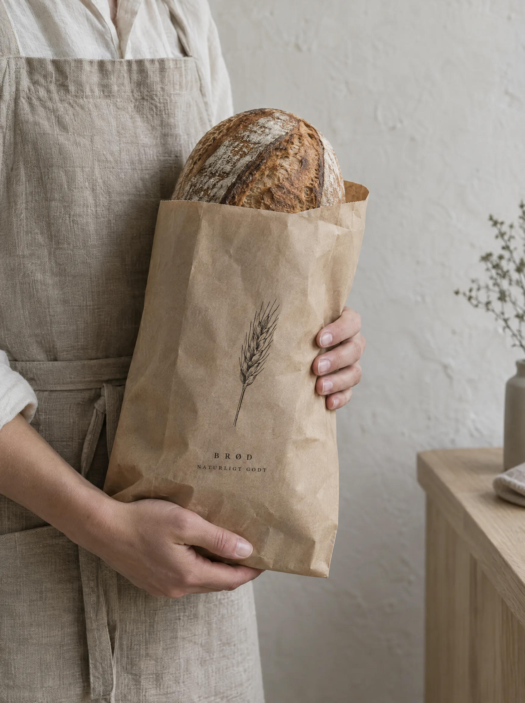 Hands holding a paper bread bag